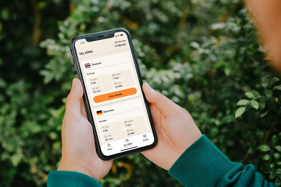 An Android phone displaying Airalo’s My eSIMs list outdoors