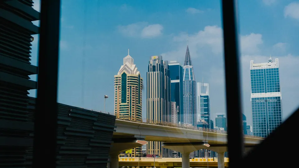 Dubai towers seen through the windows of a metro train