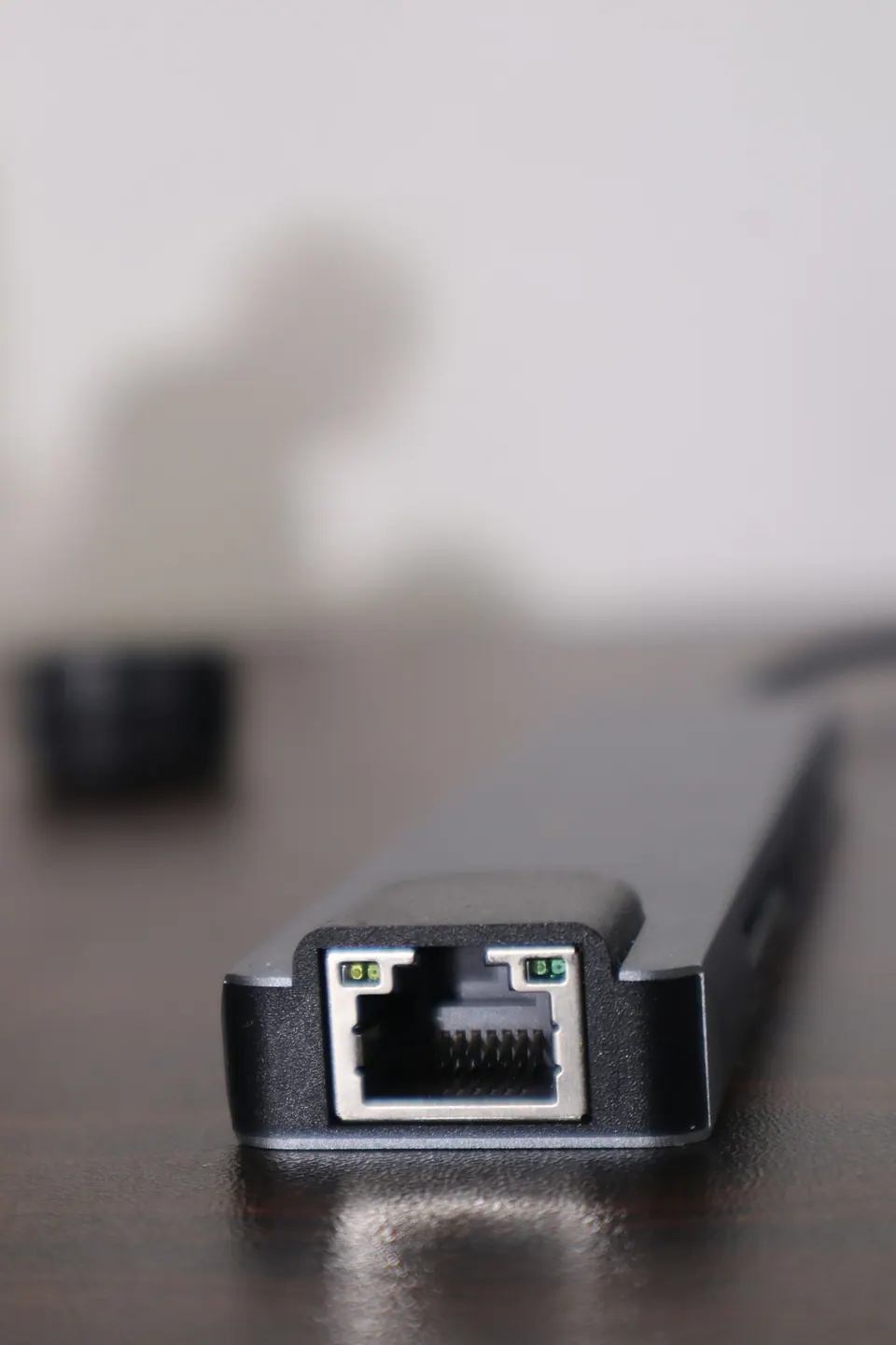 An Ethernet socket on the end of a compact USB network adapter
