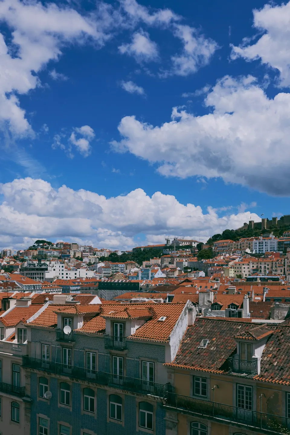 Lisbon rooftops beneath a clear blue sky